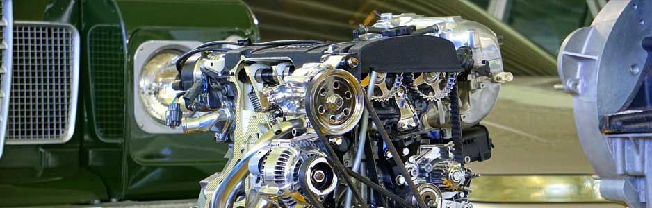 A close up photograph of a polished car engine on display at a car show