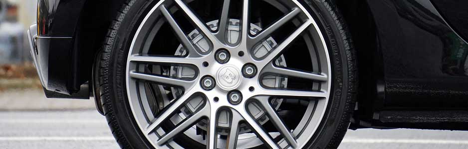 A close up photograph of a car tyre fitted to a cars wheel