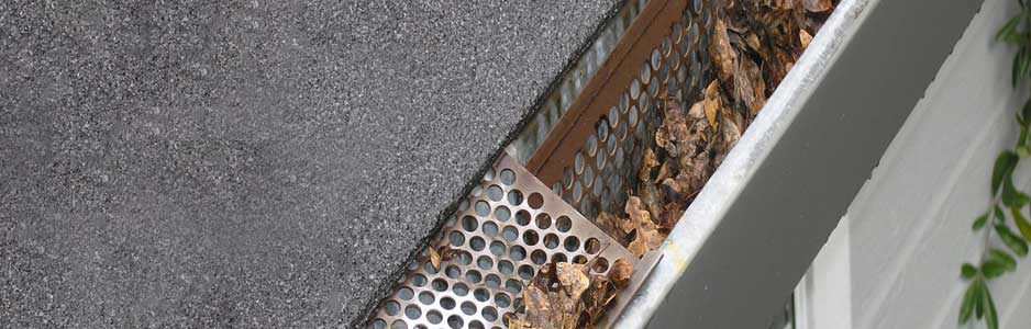 An example of a gutter filled with leaves, which can cause blockages