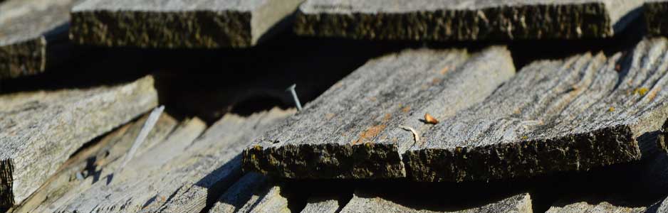 An example of wooden shingles being used by a roofer