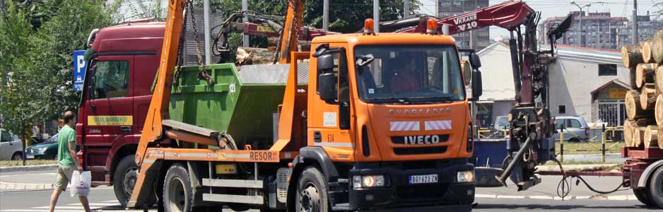 An example of a skip being transported on a lorry