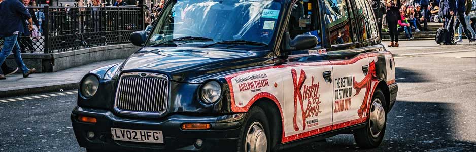 An example of a black London cab waiting to collect a passenger